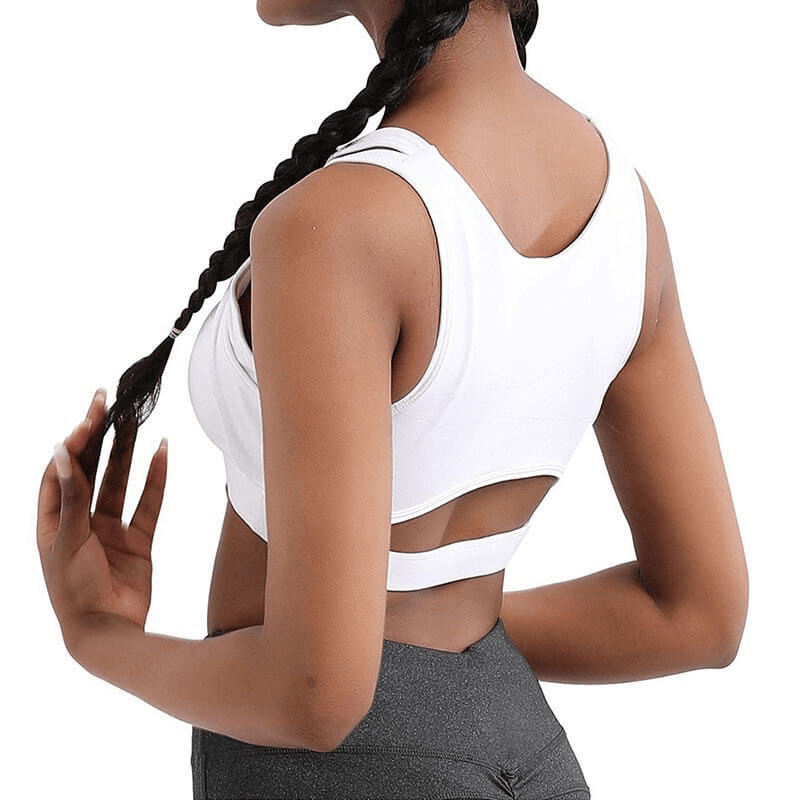 Back view of woman wearing white athletic sports bra for yoga and fitness, featuring open back design and racerback cut.
